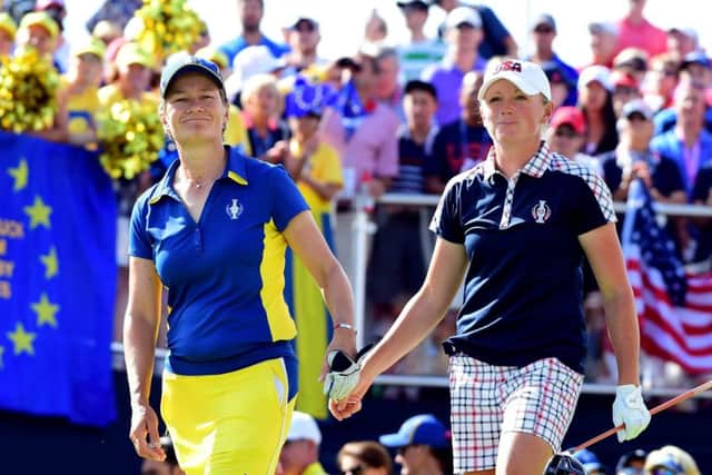 Catriona Matthew and the USAs Stacy Lewis tap hands during their singles match in the  Solheim Cup. Picture: Getty.