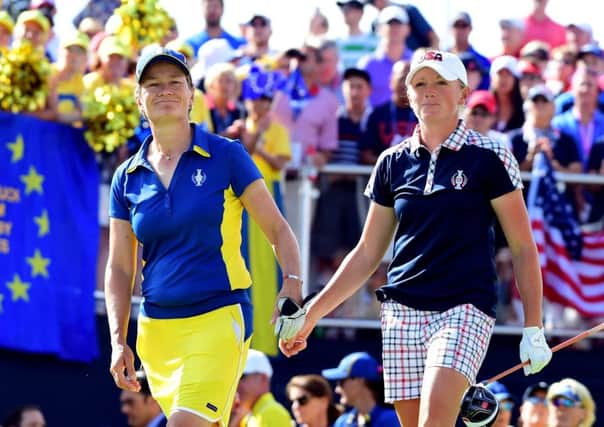 Catriona Matthew and the USAs Stacy Lewis tap hands during their singles match in the  Solheim Cup. Picture: Getty.