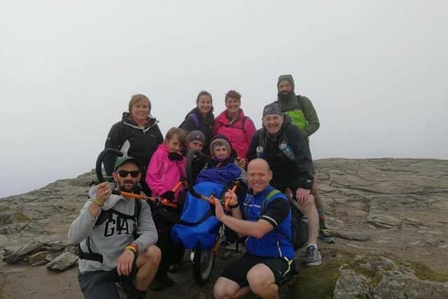 Alex and his team at the summit of Ben Lomond. Picture: SWNS
