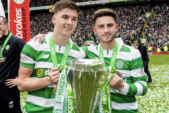 Celtic's Kieran Tierney and Patrick Roberts with the Ladbrokes Premiership crown. Picture: SNS
