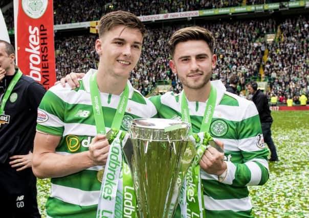 Celtic's Kieran Tierney and Patrick Roberts with the Ladbrokes Premiership crown. Picture: SNS