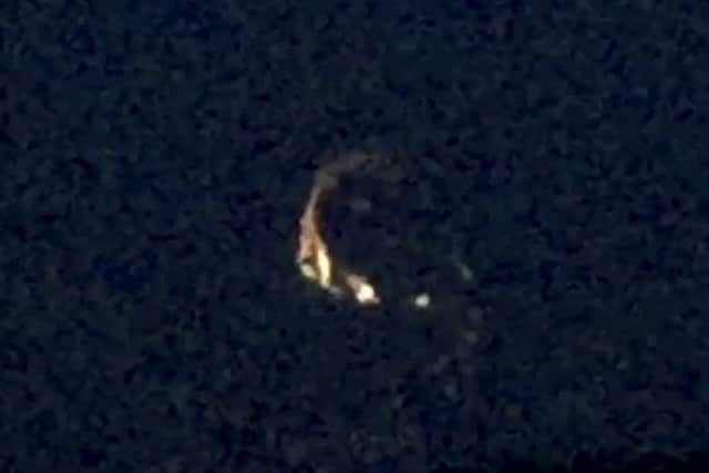 This mysterious 'UFO' has been captured on video circling over a remote country town for several minutes. Picture: SWNS