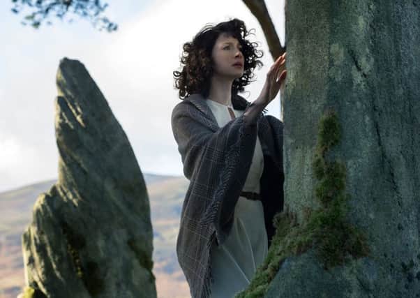 Star Caitriona Balfe touches the Clava Cairns in TV series Outlander. Picture: AP