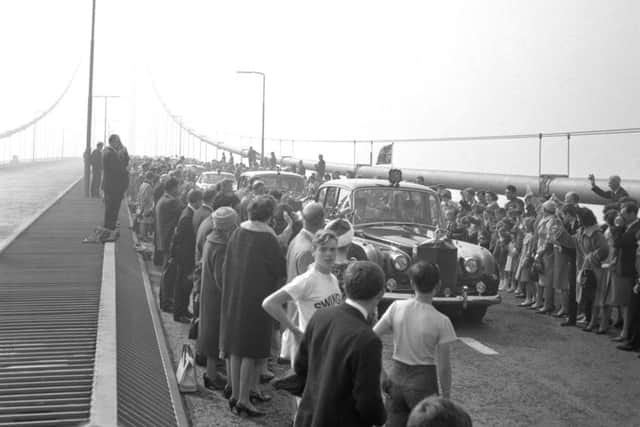 A car carrying Queen Elizabeth II passing through cheering crowds as she travels over the Forth Road Bridge after performing the opening ceremony. Picture: PA Wire
