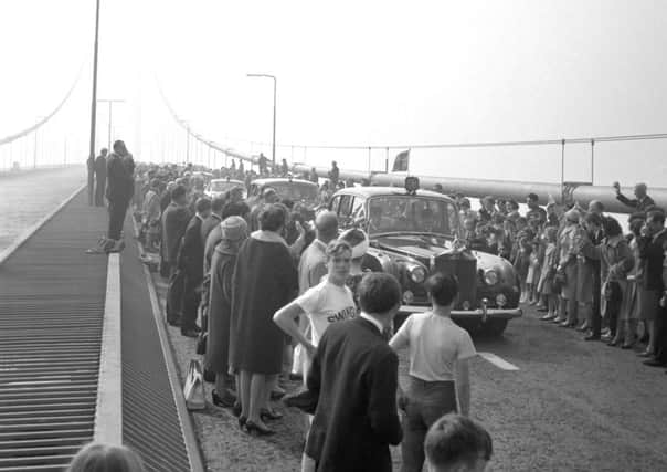 A car carrying Queen Elizabeth II passing through cheering crowds as she travels over the Forth Road Bridge after performing the opening ceremony. Picture: PA Wire