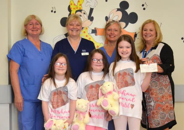 The Hoey sisters with neonatal staff. Picture: Supplied
