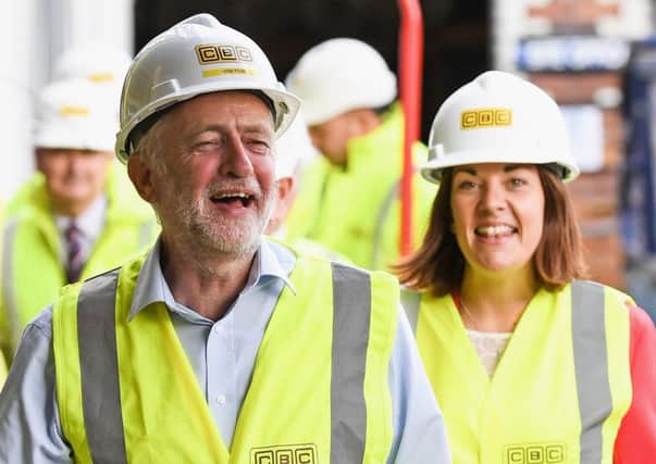 Jeremy Corbyn and Kezia Dugdale visit a Parkhead Housing Association construction site at Westmuir Street. Picture: Getty Images