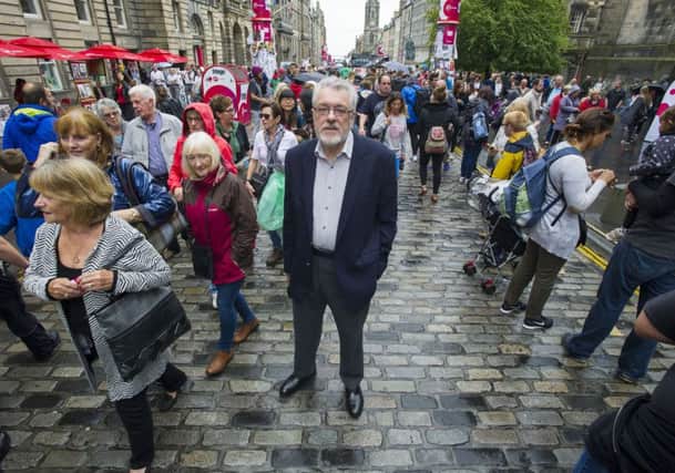 Cliff Hague pictured among the crowds and street performers on the High Street during the Edinburgh Festival Fringe. Picture: Neil Hanna