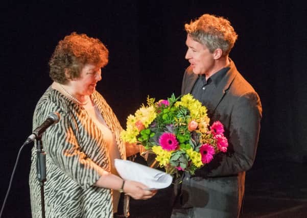 Actor Aidan Gillen presents The Scotsman theatre critic Joyce McMillan with a bouquet of flowers for covering the Fringe for 40 years
. Picture: Ian Georgeson