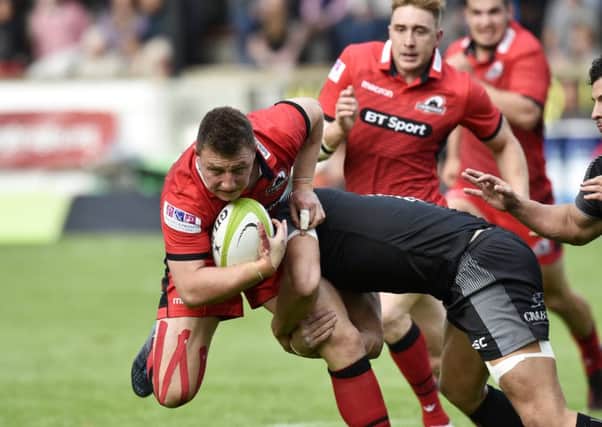Edinburgh stand-off Duncan Weir tries to force his way through the Falcons rearguard. Picture: SNS.