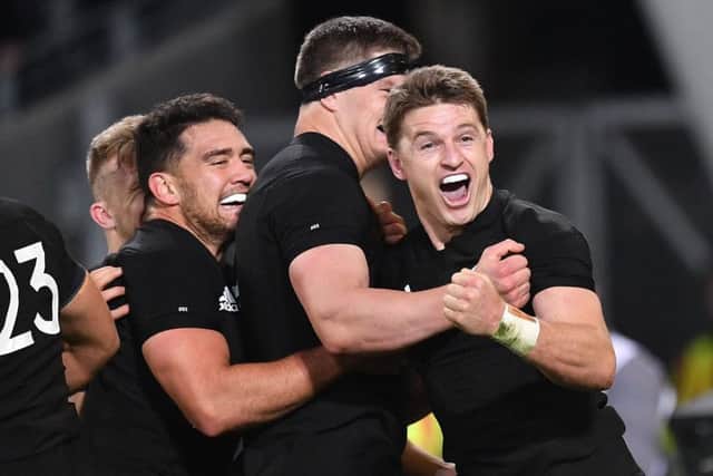 New Zealand's Beauden Barrett, right, celebrates a try with teammates Anton Lienert-Brown, left, and Scott Barrett during the second Bledisloe Cup match. Picture: Getty Images