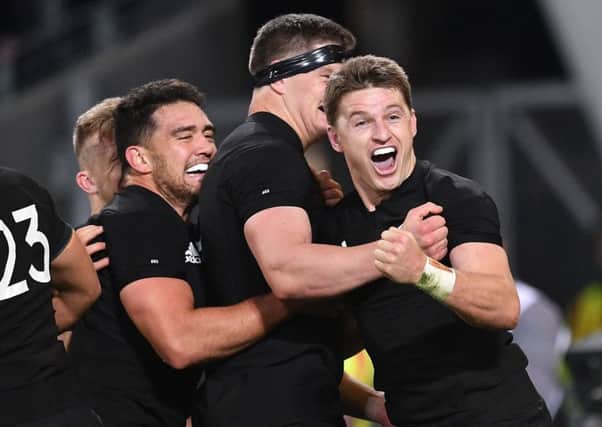 New Zealand's Beauden Barrett, right, celebrates a try with teammates Anton Lienert-Brown, left,  and Scott Barrett during the second Bledisloe Cup match. Picture: Getty Images