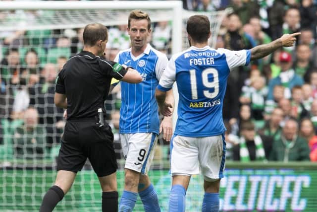St Johnstone's Steven MacLean (centre) is shown a yellow card by referee Willie Collum. Picture: SNS