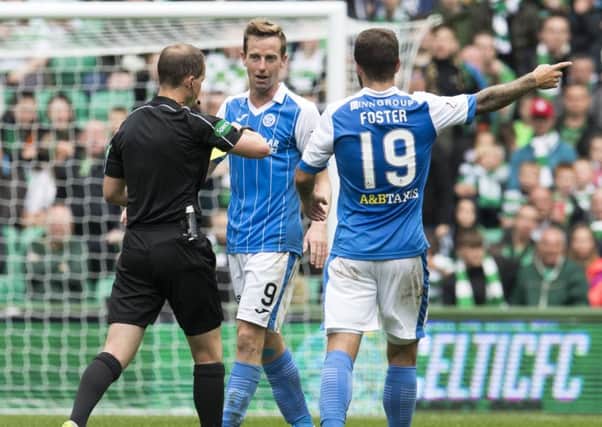 St Johnstone's Steven MacLean (centre) is shown a yellow card by referee Willie Collum. Picture: SNS