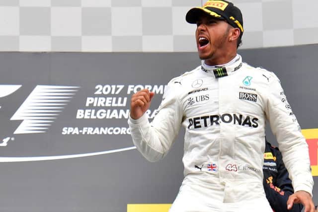 Lewis Hamilton celebrates on the podium after winning the Belgian Grand Prix at Spa-Francorchamps. Picture: Getty.
