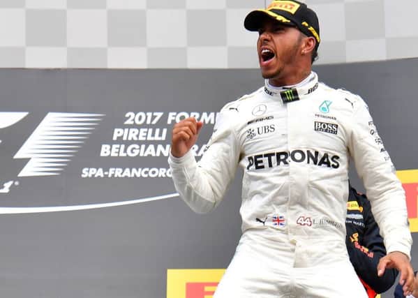 Lewis Hamilton celebrates on the podium after winning the Belgian Grand Prix at Spa-Francorchamps. Picture: Getty.