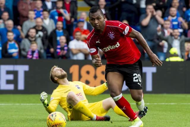 Rangers' Alfredo Morelos pinches the ball off Ross County goalkeeper Scott Fox before tapping in to make it 2-0. Picture: SNS/Craig Williamson