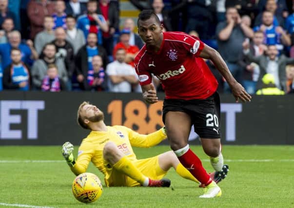 Rangers' Alfredo Morelos pinches the ball off Ross County goalkeeper Scott Fox before tapping in to make it 2-0. Picture: SNS/Craig Williamson