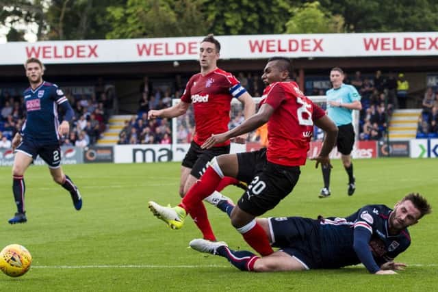 Ross County's Jason Naismith slides in to challenge Alfredo Morelos as the away side appeal for a penalty. Picture: SNS