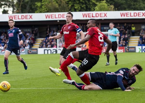 Ross County's Jason Naismith slides in to challenge Alfredo Morelos as the away side appeal for a penalty. Picture: SNS