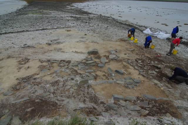 Archaeologists work on remains of early Neolithic house. PIC: UHI Archaeology Institute