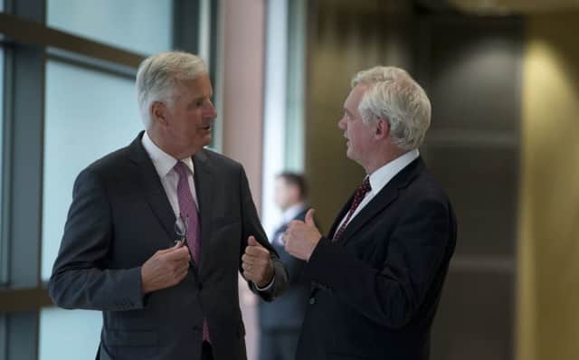 EU chief negotiator Michel Barnier speaks with British Secretary of State David Davis. Picture: AP