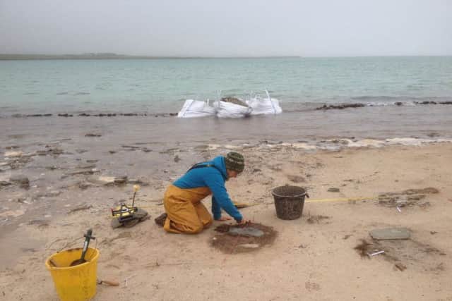 Archaeologists battling against the sea at Cata Sand. Picture: Contribution.