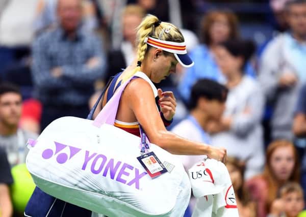 Dejected  Angelique Kerber leaves the court after her shock defeat by Naomi Osaka. Picture: AFP/Getty.
