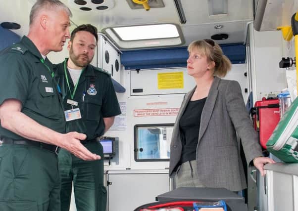 Health Minister Shona Robison, seen here with ambulance workers, has seen waiting times fall short of targets on her watch.