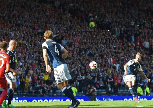 Leigh Griffiths scores from  a free-kick to put Scotland 2-1 up against England with only minutes to go at Hampden in June.