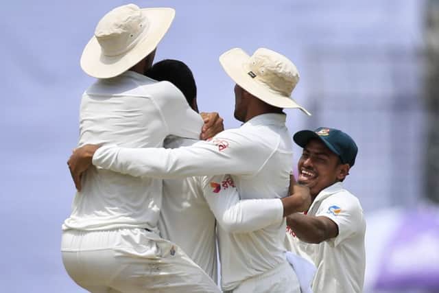 Shakib Al Hasan is mobbed by team-mates after dismissing Australia's Glenn Maxwell. Picture: A.M. Ahad/AP
