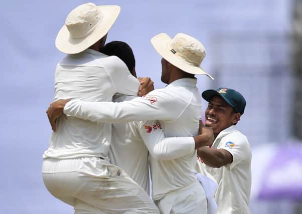Shakib Al Hasan is mobbed by team-mates after dismissing Australia's Glenn Maxwell. Picture: A.M. Ahad/AP