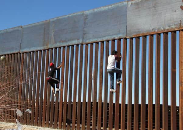 TOPSHOT - Boys play around, climbing the border division between Mexico and the US in Ciudad Juarez. Picture: HERIKA MARTINEZ/AFP/Getty Images