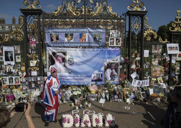 Well-wishers and Royal 'enthusiasts' gather outside the gates of Kensington Palace where tributes continue to be left, on the 20th anniversary of the death of Princess Diana Picture: Dan Kitwood/Getty Images