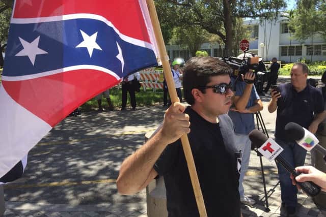 Chris Tedino in Florida, a member of the League of the South, protests against a proposal to strip the names of Confederate Gens Robert E. Lee, Nathan Bedford Forrest and John Bell Hood from city streets. (AP Photo/Terry Spencer)