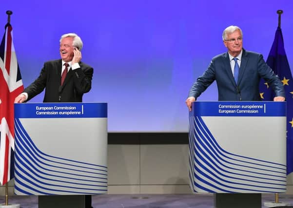 British Secretary of State for Exiting the European Union (Brexit Minister) David Davis (L) and EU chief Brexit negotiator Michel Barnier address media. Picture: Getty Images