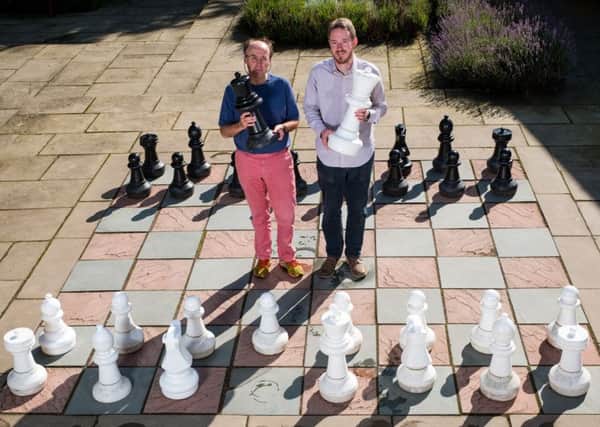 Professor Ian Gent, and Dr Peter Nightingale attempt the puzzle with the giant chess set at Falkland Palace. Picture: Stuart Nicol/Contributed