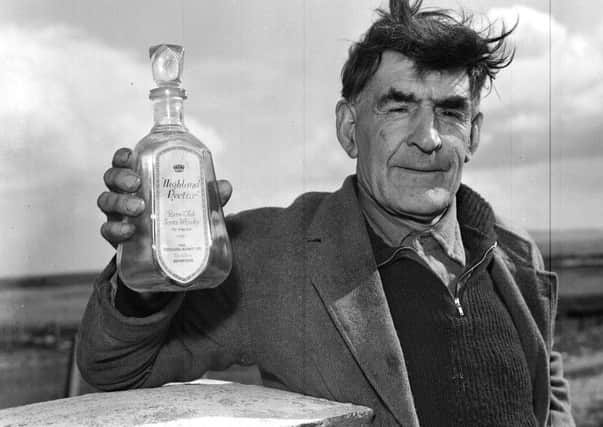 John Morrison with an empty bottle of Highland Nectar whisky he liberated from the SS Politician in 1941. Picture: TSPL