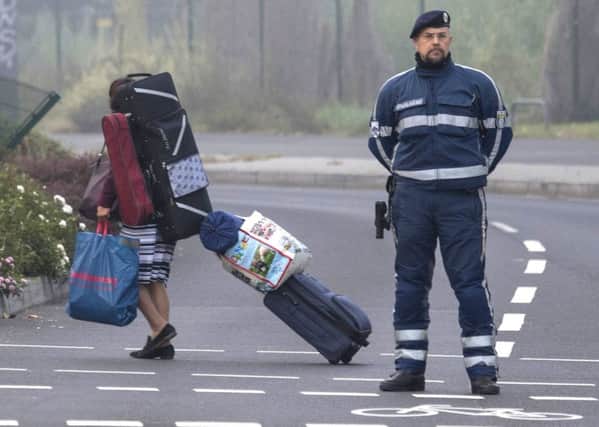 A woman carries her belongings during the evacuation of more than 60 000 people in Frankfurt, Germany. Picture: Boris Roessler/dpa via AP