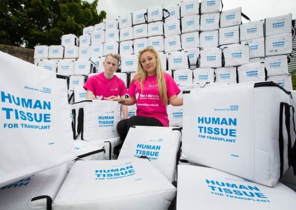 Isabel Sewell, 20, and Charles Duke, 22, who are both on the organ transplant waiting list, with empty transplant boxes at the NHSBT warehouse in Bristol. Picture: Richard Crease/NHSBT/PA Wire