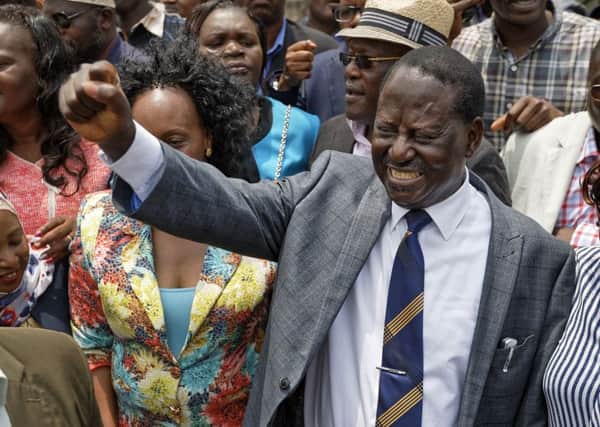 Opposition leader Raila Odinga raises a fist as a sign of victory to his supporters as he leaves the Supreme Court in downtown Nairobi, Kenya. Picture: AP Photo/Ben Curtis