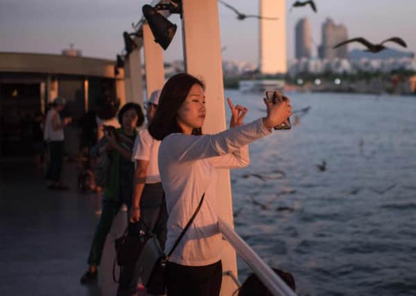 Taking a selfie can help detect cancer. Picture: ED JONES/AFP/Getty Images