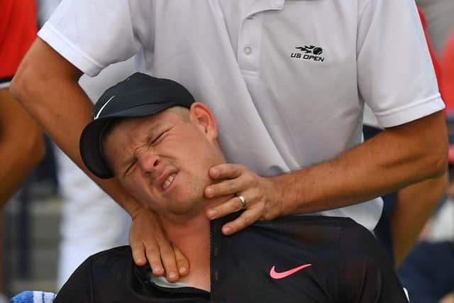 Kyle Edmund receives treatment on his neck from a trainer during his match against Denis Shapovalov. Picture: AFP/Getty
