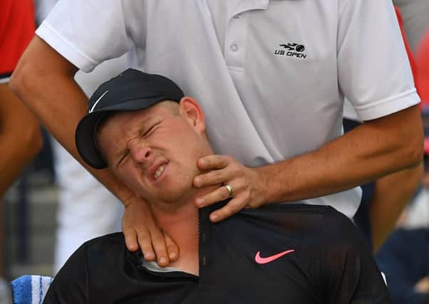Kyle Edmund receives treatment on his neck from a trainer during his match against Denis Shapovalov. Picture: AFP/Getty