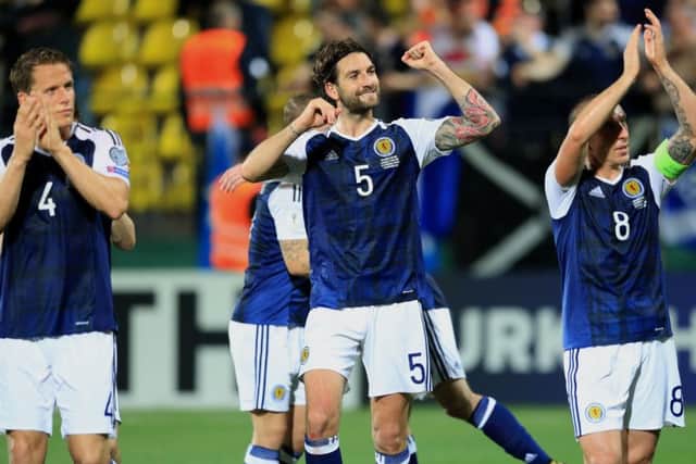 Scotland's Charlie Mulgrew (centre) and his team-mates celebrate after the victory in Lithuania. Picture: PA