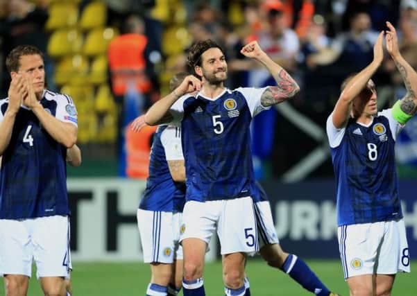 Scotland's Charlie Mulgrew (centre) and his team-mates celebrate after the victory in Lithuania. Picture: PA