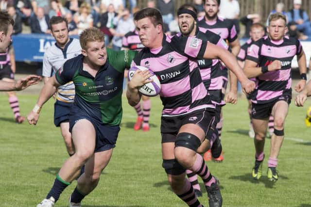 Ayr's Tommy Spinks tries to escape the clutches of Muir's Johnny Matthews. Picture: Ian Rutherford