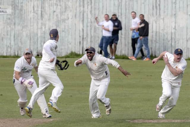 Prestwicks Fraser McDonald, Tom Fleet (back to camera), Shazad Rafiq and Ross Paterson celebrate the wicket of Heriots Mark Watt.  Photograph: Donald MacLeod