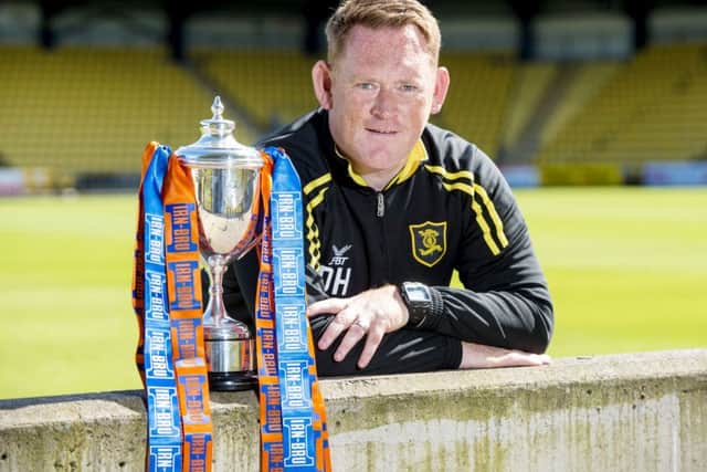 Livingston boss David Hopkin poses with the Irn-Bru Cup before the clash in Wales. Picture: SNS Group