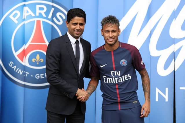 File photo dated 04-08-2017 of Neymar is unveiled alongside Paris Saint Germain president Nasser Al-Khelaifi during a press conference at the Parc des Princes, following his world record breaking £200million transfer from FC Barcelona to Paris Saint Germain. PRESS ASSOCIATION Photo. Issue date: Friday September 1, 2017. UEFA has announced it has opened a Financial Fair Play investigation into Paris St Germain. See PA story SOCCER Paris St Germain. Photo credit should read Jonathan Brady/PA Wire.